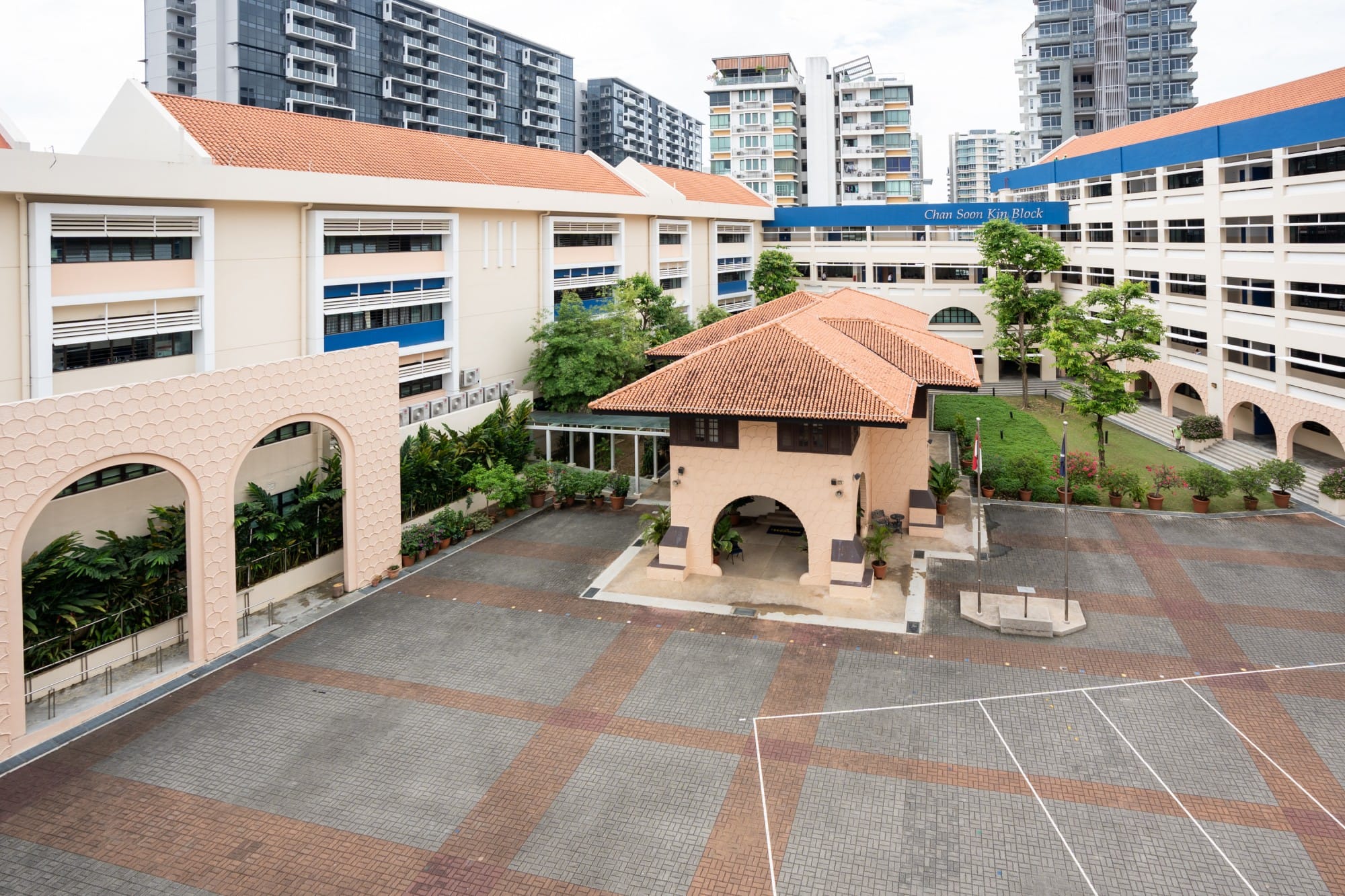 Woodsville House - School courtyard with terracotta roofs, arched walls, brick paving